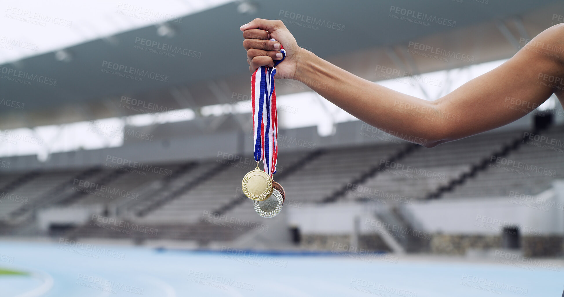 Buy stock photo Sport, winner and hands of runner with medals at stadium for track champion, success and victory. Athlete, person and awards outdoor for running achievement, performance prize and competition reward