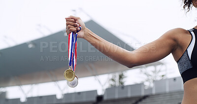 Buy stock photo Sport, winner and hands of athlete with medals at stadium for track champion, success and victory. Runner, woman and awards outdoor for running achievement, performance prize and competition reward
