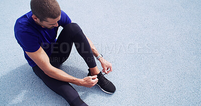 Buy stock photo Runner, tie laces and above of man on race track for fitness, cardio challenge and marathon practice. Workout, competition training and sneakers with person in sports stadium for exercise and athlete