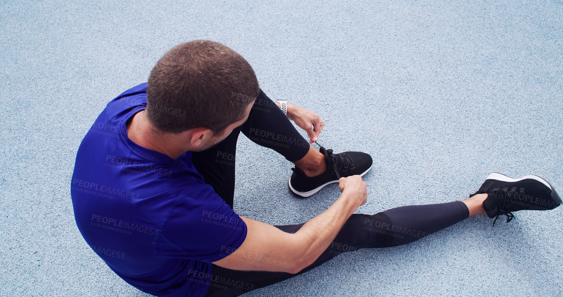 Buy stock photo Athlete, tie laces and above of man on race track for fitness, cardio challenge and marathon practice. Workout, competition training and sneakers with person in sports stadium for exercise and runner