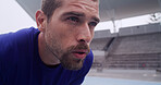 Athlete, man and tired with breathe at stadium for fatigue, race break or competition with burnout. Fitness, workout and runner training for marathon, endurance challenge or exhausted for recovery