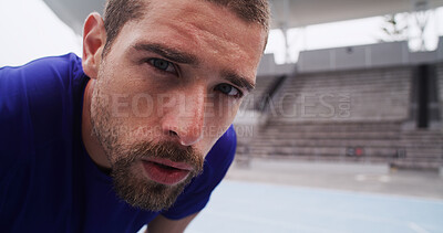 Buy stock photo Portrait, sports and tired man rest at race track for exercise recovery, health or serious face. Stadium, breathe and break for fitness, cardio challenge and runner sweat with determination or space