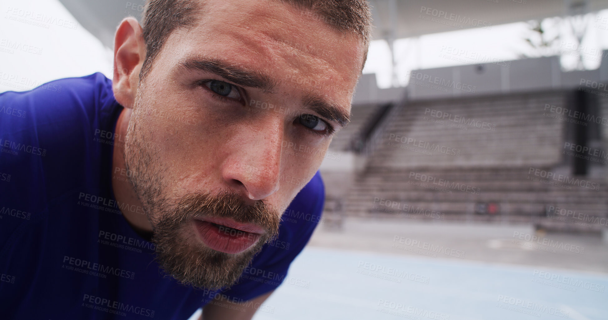 Buy stock photo Portrait, sports and tired man rest at race track for exercise recovery, health or serious face. Stadium, breathe and break for fitness, cardio challenge and runner sweat with determination or space