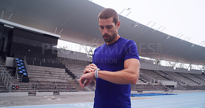 Buy stock photo Man, athlete and smart watch at stadium for training, stats and heart rate for exercise routine on track. Person, thinking and break with iot clock, stopwatch and fitness app for sport in New Zealand
