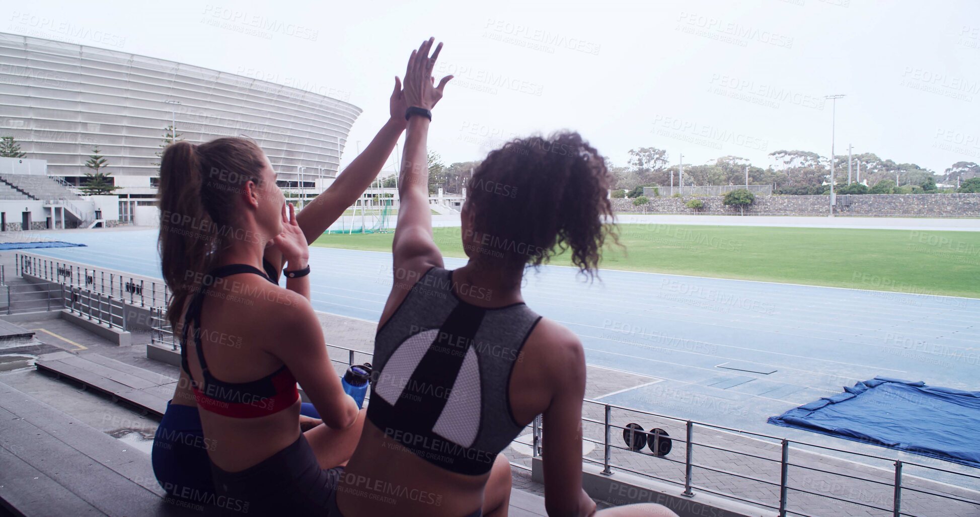 Buy stock photo Exercise, friends and celebration with high five in stadium for workout, marathon race or running. Back of women, excited and outdoor challenge for fitness, teamwork or support for cardio achievement