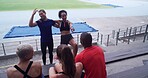 Couple of friends, athlete and funny people at stadium for sports break, talking and fitness at training. Happy, laughing and runner group relax together for joke, pointing and exercise outdoor