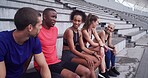 Conversation, fitness and rest with friends on stadium bleachers for bonding or sports training. Break, exercise and recovery with group of athlete people speaking in venue for workout discussion