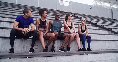Buy stock photo Conversation, break and fitness with friends on venue bleachers for bonding or sports training. Discussion, exercise and rest with group of athlete people speaking in stadium for workout recovery