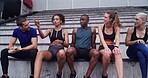 Athlete, people and talk on stairs at stadium for planning, fitness break and competition advice. Group, friends or rest for exercise discussion, training tips and race feedback of sports tournament
