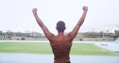 Buy stock photo Man, athlete and celebration on track for goals, personal record or back for training at stadium. Person, runner and topless for fist pump, success or exercise for sports, workout or fitness in Italy