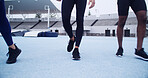 Runner, walking and athlete with legs on race track for marathon practice, workout and cardio challenge. Sports, exercise and competition with people in stadium for health, training and fitness