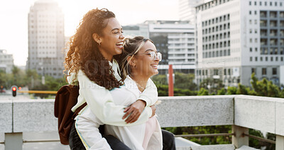Buy stock photo Piggy back, students and women in city for travel, commute and walking for adventure on weekend. University, friends and happy people in urban town for break, vacation and holiday together outdoor