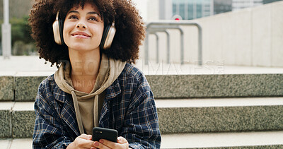 Buy stock photo Headphones, thinking and woman with phone in city for music, podcast and audio on college break. University campus, stairs and student on smartphone listening to radio, track and playlist in town