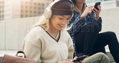 Buy stock photo Stairs, headphones and woman with smartphone, browsing and listen to music, online and social media. Happy, person and streaming playlist on website, communication and chat with contact in city