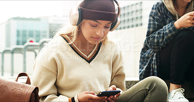 Buy stock photo City, headphones and woman with smartphone, browsing and communication with contact on social media. Calm, online and person with mobile for message, streaming and listening to music, relax and radio