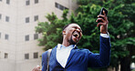 Business, man and celebration with phone in city for good news, commute and success notification. Excited, black person and victory fist in town for career opportunity, job promotion email and goals