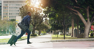 Buy stock photo Business, city and black man running late with luggage for travel, urban commute and journey. African worker, suitcase and rush outdoor with speed, hurry or delay with flight for work trip with flare