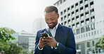 Business, city and phone with happy black man reading text message for real estate feedback or update. App, communication and smile with African employee outdoor for commercial property development