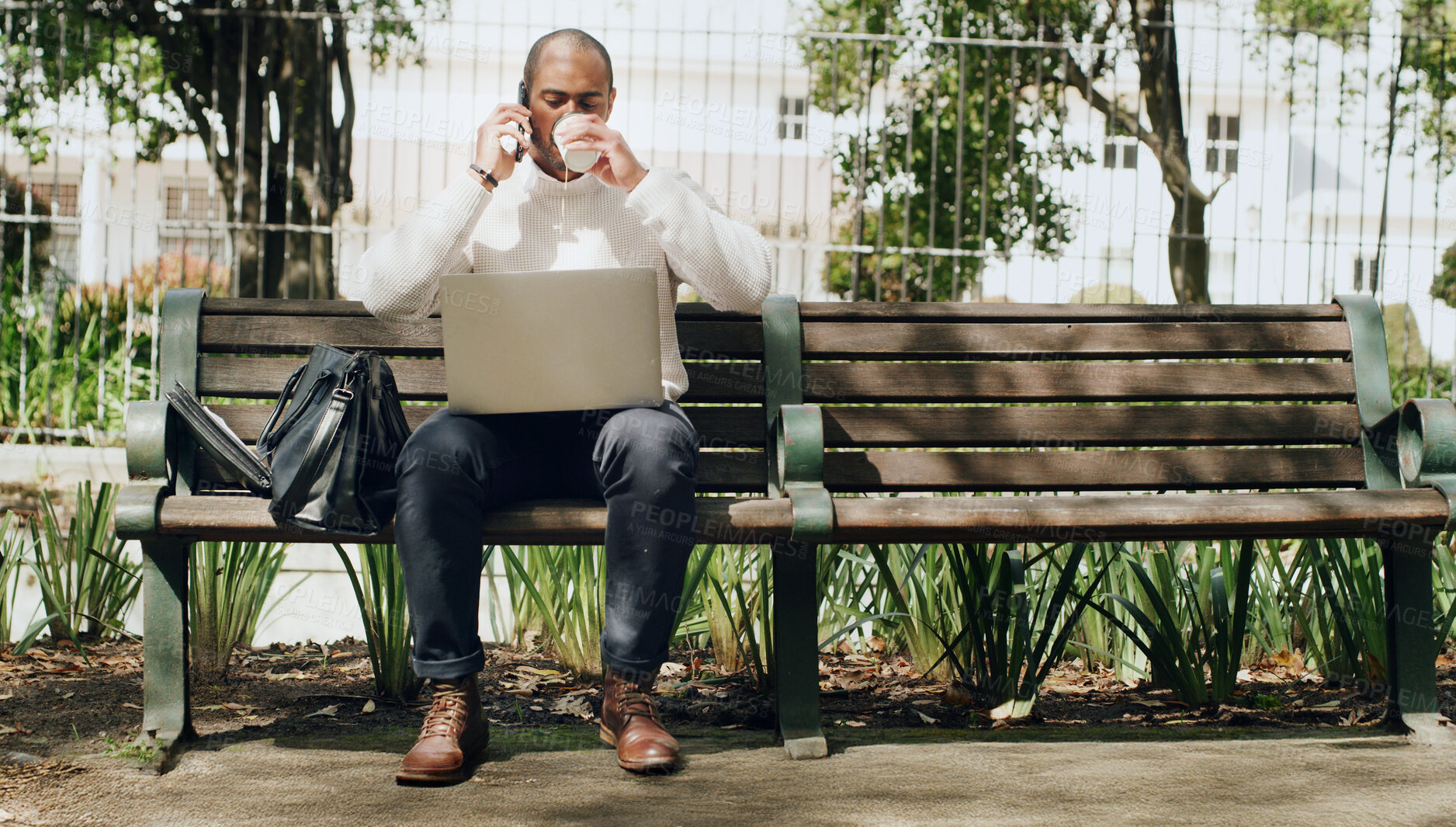 Buy stock photo Businessman, phone call and coffee with laptop on bench for business discussion or conversation. Man, freelancer or remote work on mobile smartphone, computer or drink for chat or negotiation in park