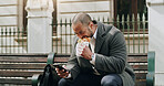Man, phone and eating food in city for travel, browsing social media and lunch break. Male person, relax and mobile app with meal on bench, direction search and notification update for urban commute