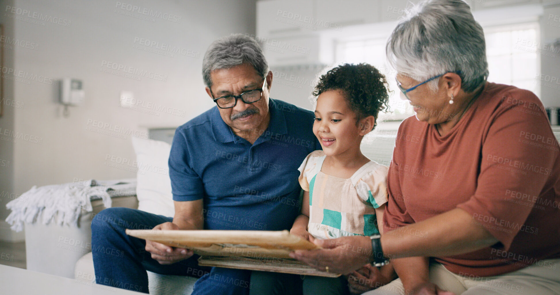 Buy stock photo Grandparents, child and photo frame in home with family for funny memory or learning history. Kid, grandmother and grandfather with picture on sofa for nostalgia, smile and bonding with generations