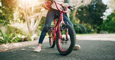 Buy stock photo Legs, bicycle and child at park, outdoor and helmet for protection, learning and ride in nature. Kid, bike and cycling with safety gear, wheels or ppe for fun with adventure on road in summer