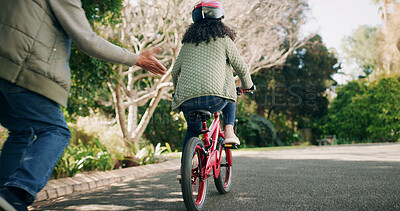 Buy stock photo Father, hands and teaching child on bicycle with support, learning skills and development in road. Back, safety and parent with girl on bike for cycling, trust and childhood memory in neighborhood