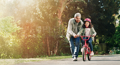 Buy stock photo Teaching, grandfather and child on bicycle outdoor with safety, learning skills and development. Flare, space and senior man with girl on bike for cycling, trust or support with hobby in neighborhood