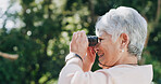 Smile, senior woman and binocular outdoor for travel, bird watching and holiday sightseeing. Happy, elderly person and nature observation with equipment, wildlife study and view of vacation discovery