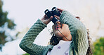 Smile, child and check binocular at park for travel, bird watching and holiday sightseeing. Happy, girl and equipment for nature observation, wildlife study and scenery view for vacation discovery
