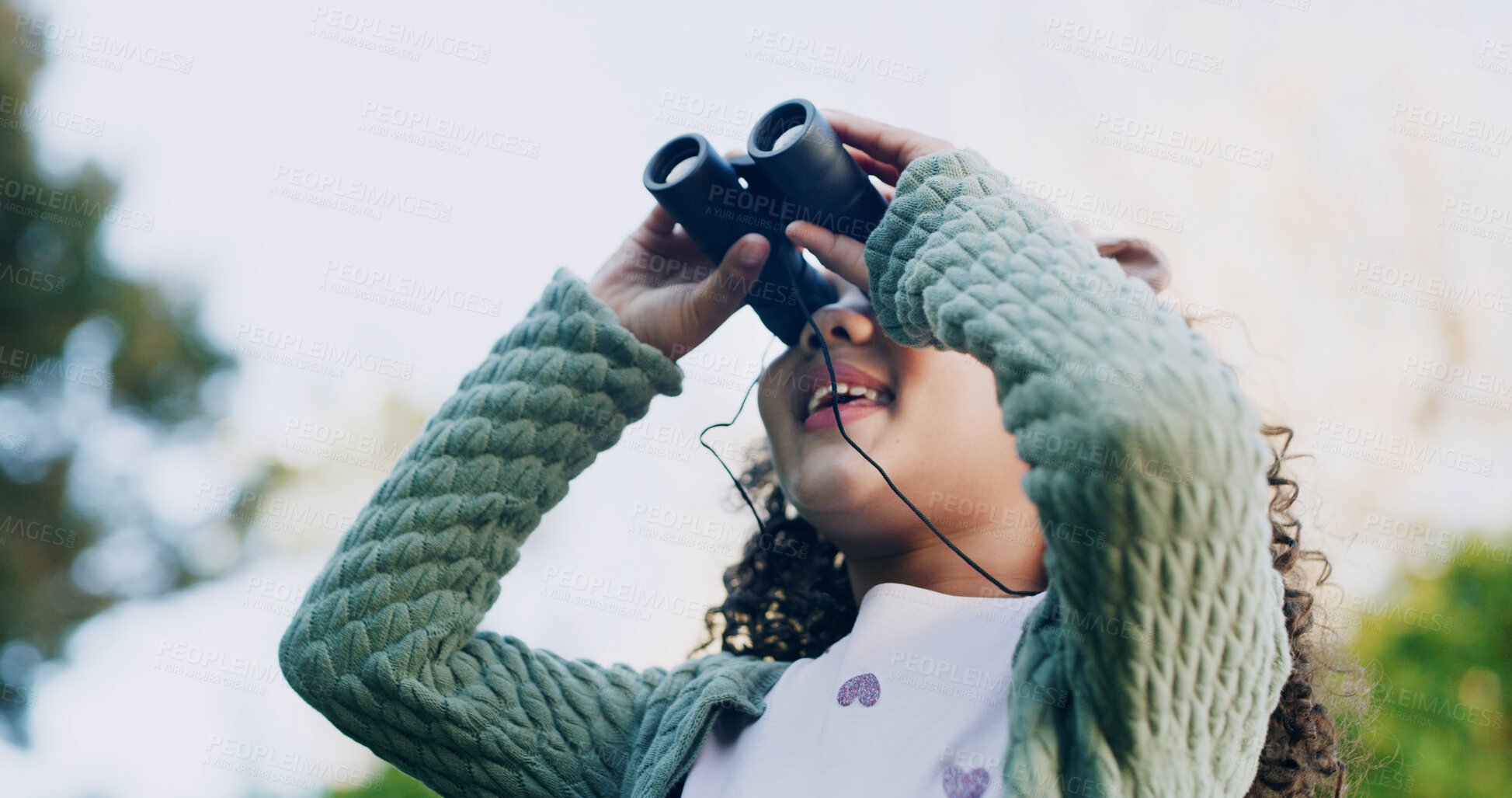 Buy stock photo Smile, child and check binocular at park for travel, bird watching and holiday sightseeing. Happy, girl and equipment for nature observation, wildlife study and scenery view for vacation discovery
