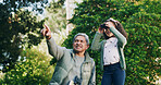 Grandfather, child and binocular in park for travel, sightseeing and pointing with view for bonding. Man, girl and explore for adventure, bird watching or fun together in nature with family in Mexico