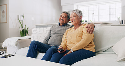 Buy stock photo Hug, smile and watching tv with old couple on sofa in living room of home for bonding or streaming. Love, relax and retirement with senior people in apartment together for television entertainment