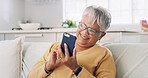 Senior woman, phone and happy on sofa for text message, reading ebook and search online news. Retirement, old person and relax with smartphone in home for social media update and download mobile app