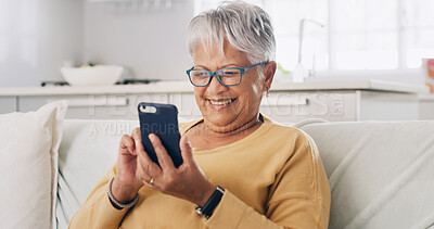 Buy stock photo Senior woman, phone and smile on sofa for typing message, reading ebook or search online news. Retirement, old person and relax with smartphone in home for social media update or playing puzzle game