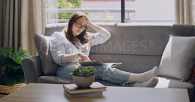 Buy stock photo Woman, student and book on sofa in home, relax or education with DNA research in living room. Person, science literature and medical studies with thinking, scholarship or learning with smile at house