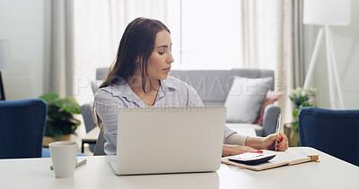 Buy stock photo Calculator, laptop and writing with woman in living room of home for financial planning or remote work. Computer, finance and money with freelance employee at desk in apartment for accounting budget