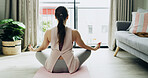 Zen, woman and meditation in home, lotus or routine for mindfulness, self awareness or peace on mat. Healthy, person and stress relief in living room, back and wellness with yoga or calm in house