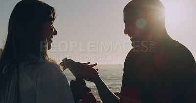 Buy stock photo Love, holding hands and holiday with couple at beach for travel, summer and flowers. Sunset, support and vacation with smile, man and woman on seaside date for commitment, care and trust together