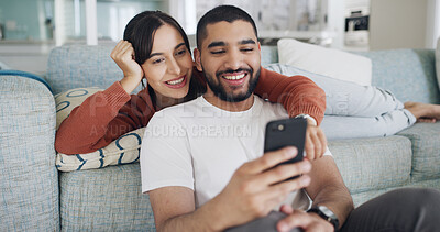 Buy stock photo Phone, relax and smile with couple on sofa in living room of home together for social media browsing. App, communication or text message with man and woman in apartment for bonding or wellness
