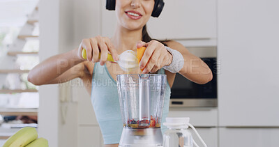 Buy stock photo Headphones, smoothie and hands of a woman for healthy diet, nutrition and fruit in kitchen. Orange juice, blender and female person with vegan ingredients for drink, shake or streaming music in home