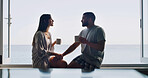 Ocean, love and couple with coffee, home and bonding together with romance, relax and morning. Apartment, seaside and man with woman, view and cappuccino with break, conversation and relationship