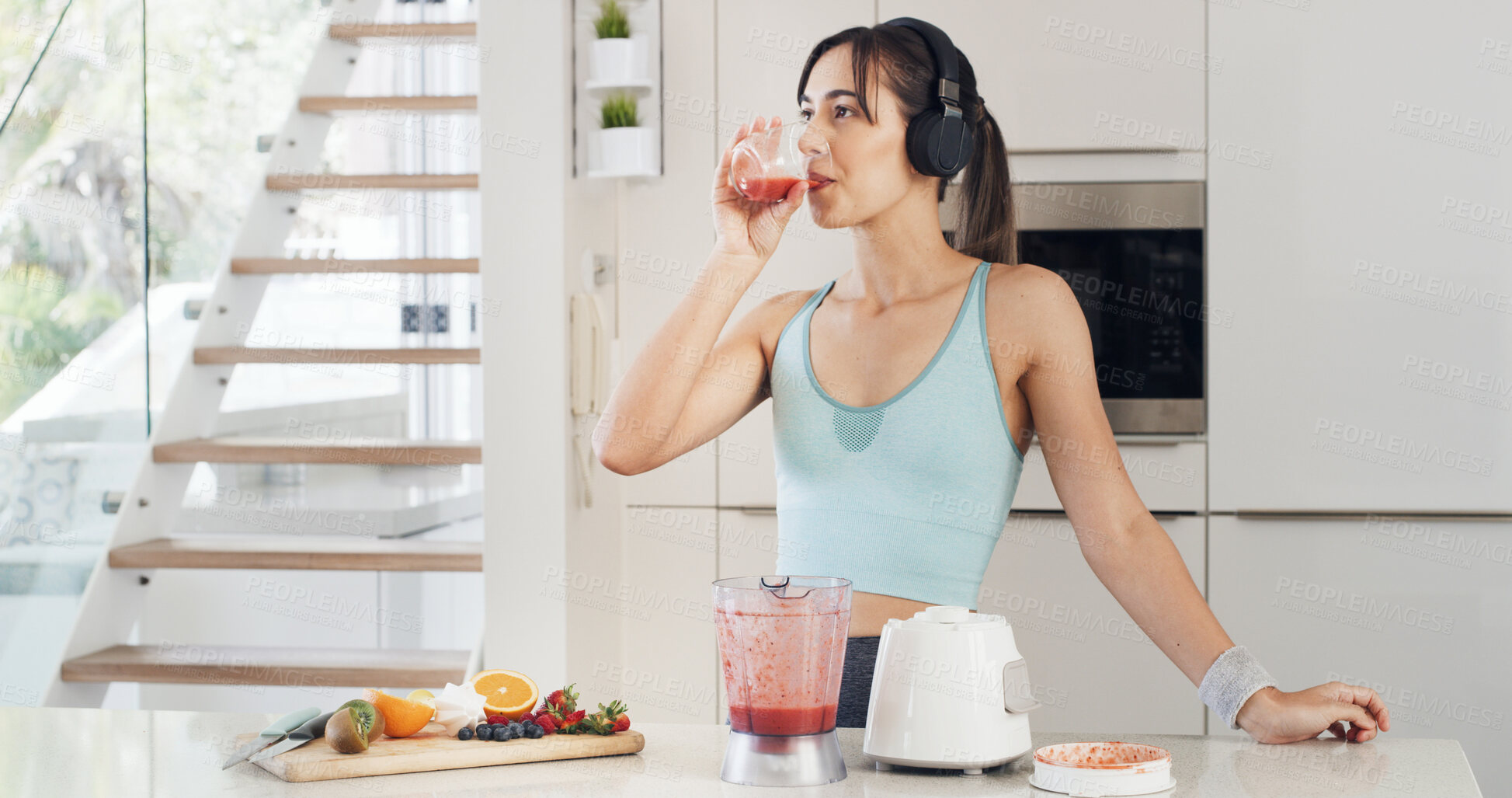 Buy stock photo Headphones, drinking smoothie and woman with healthy diet, nutrition and fruit in kitchen. Taste, blender and female person with vegan ingredients for drink, shake or streaming music in home
