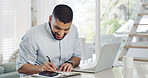 Smile, man and writing in notebook at house of accounting, financial planning and bills payment. Male person, diary and laptop for mortgage checklist, budget information and finance notes of expenses