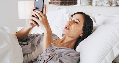 Buy stock photo Reading, phone and woman relax in bedroom for text, message and post on social media app. Morning, bed and girl in home with mobile for communication, check news and online chat with notification