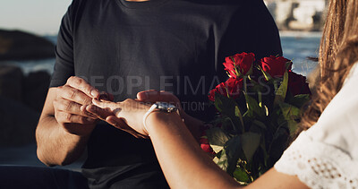Buy stock photo Engagement, love and hands of couple at beach for marriage proposal, romance and support. Wedding ring, roses and vow renewal on anniversary with man and woman for commitment and save the date