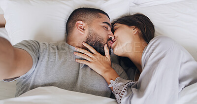Buy stock photo Morning, couple and selfie with kiss, smile and love for romance in bedroom. Man, woman and commitment with honeymoon memory, photography and hotel with vacation together and social media post
