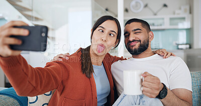 Buy stock photo Couple, selfie and funny face on sofa, home and happy for hug, care and coffee for post on web. Woman, man and joke with embrace, love or photography for profile picture on social media at apartment