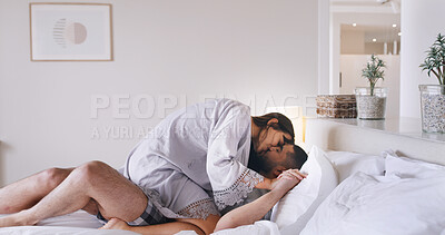 Buy stock photo Couple, rest and kiss on bed at house for love, romance and calm morning on honeymoon. People, relax and intimate with partner, affection and bonding together for marriage commitment at accommodation