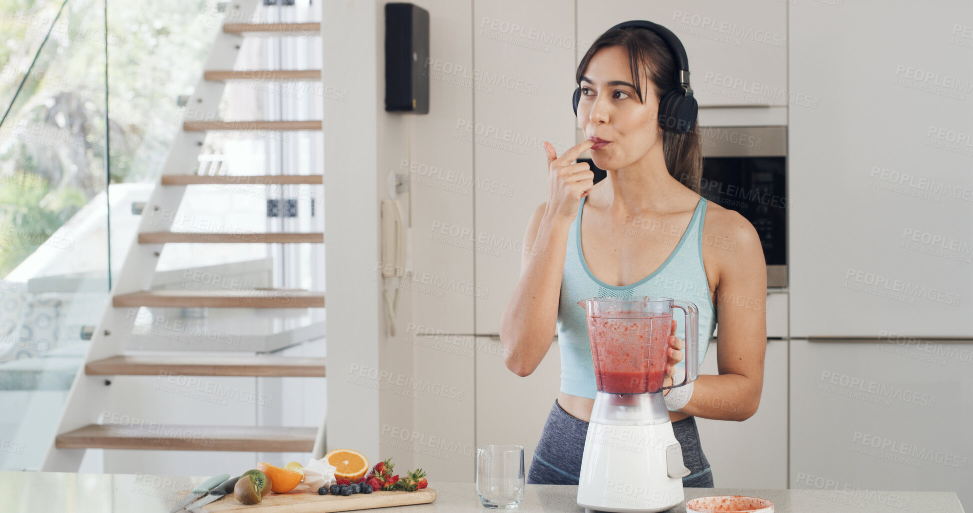 Buy stock photo Headphones, smoothie and thinking with a woman for healthy diet, nutrition and fruit in kitchen. Taste, blender and female person with vegan ingredients for drink, shake or streaming music in home
